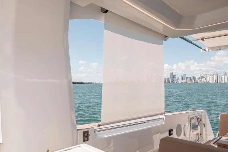 Slide: The Image of 2024 Fjord Boats 53XL yacht with city skyline view, featuring modern design and open water. - 27