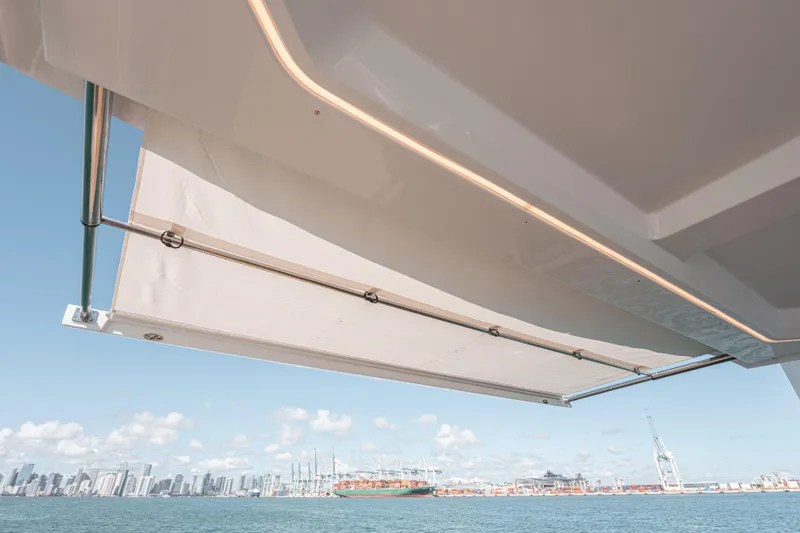 Slide: The Image of 2024 Fjord Boats 53XL yacht with sunshade, city skyline and harbor view. - 29