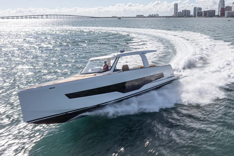 Slide: The Image of 2024 Fjord Boats 53XL cruising on open water near city skyline. - 3