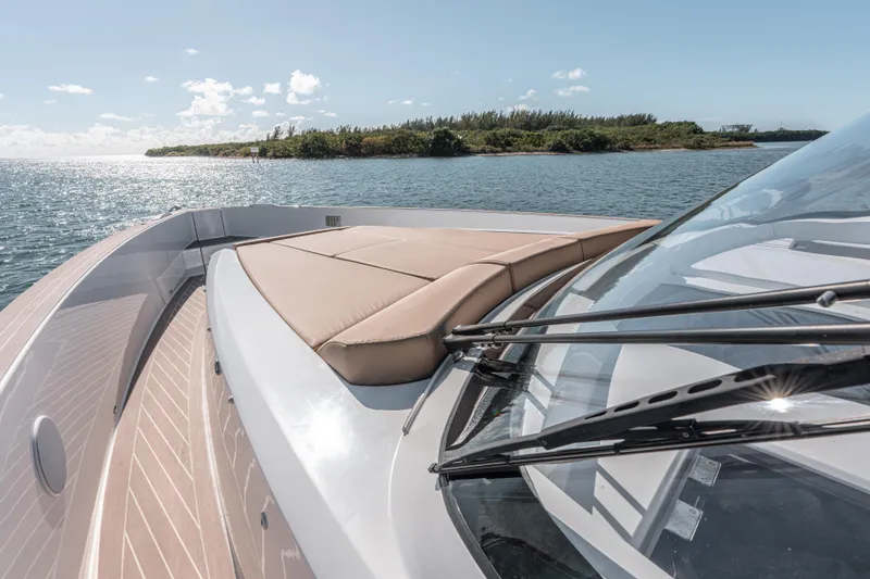 Slide: The Image of 2024 Fjord Boats 53XL luxury yacht with sun deck, cruising on serene waters. - 30