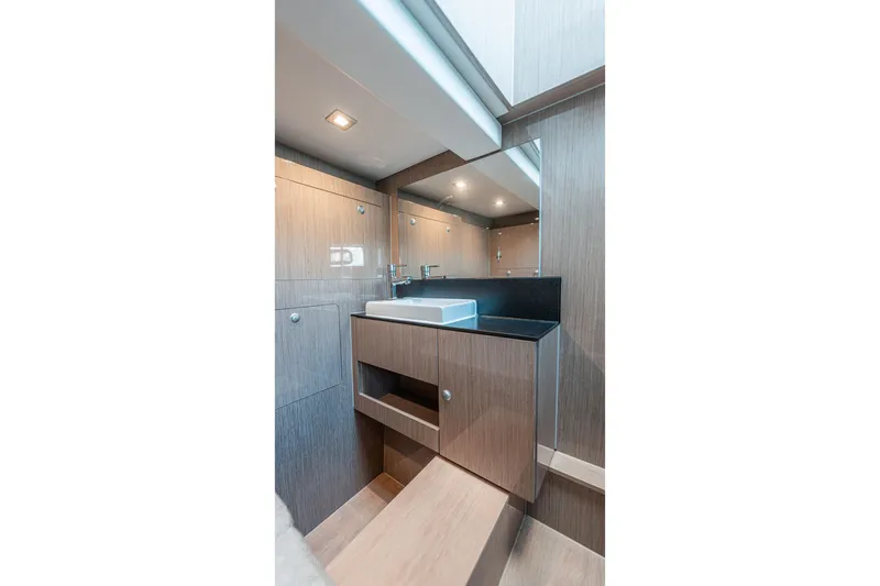 Slide: The Image of Luxurious bathroom interior of 2024 Fjord Boats 53XL, featuring modern sink and wood finish. - 46