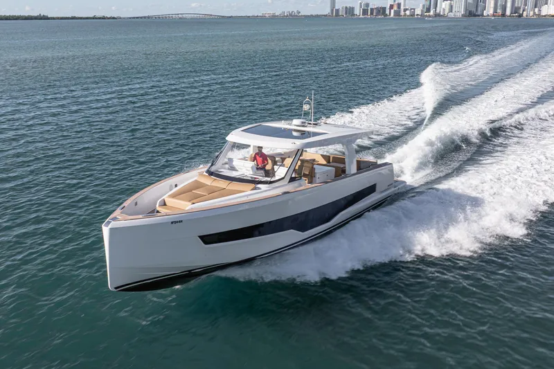 Slide: The Image of 2024 Fjord Boats 53XL cruising on open water near city skyline. - 6