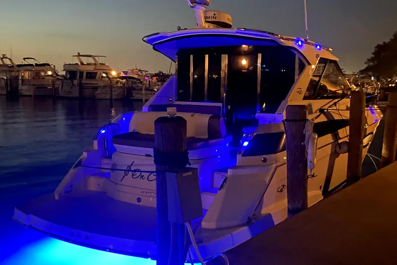 Slide: The Image of 2016 Regal 42 Sport Coupe with blue lights docked at night. - 6