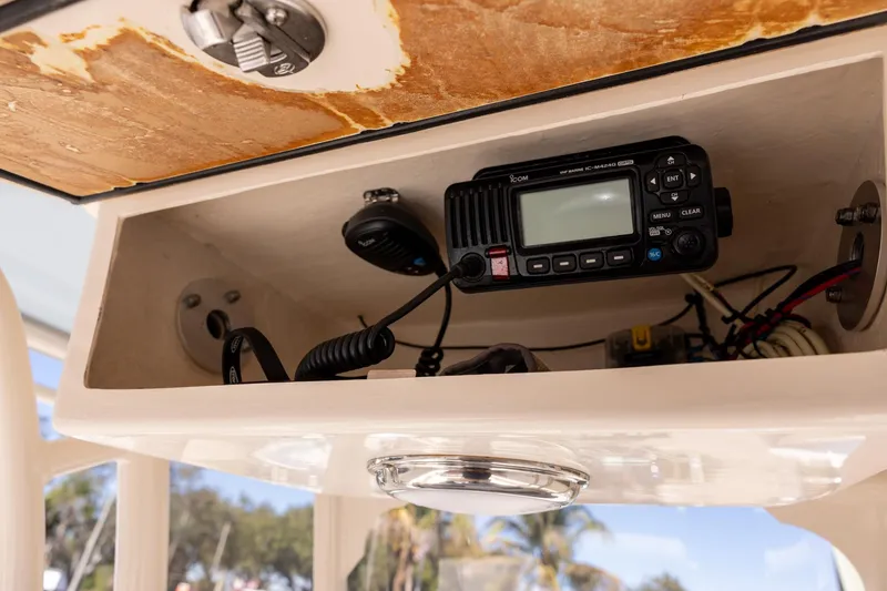 Slide: The Image of 2021 Grady-White 251 Coastal Explorer boat radio compartment with communication equipment. - 15