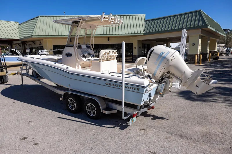 Slide: The Image of 2021 Grady-White 251 Coastal Explorer boat on trailer, parked outside dealership. - 2