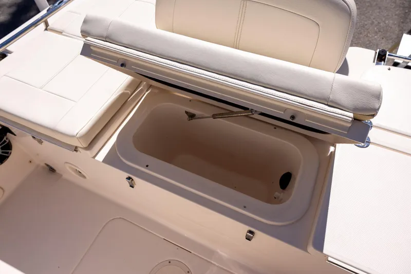 Slide: The Image of 2021 Grady-White 251 Coastal Explorer boat with open storage compartment and cushioned seating. - 9
