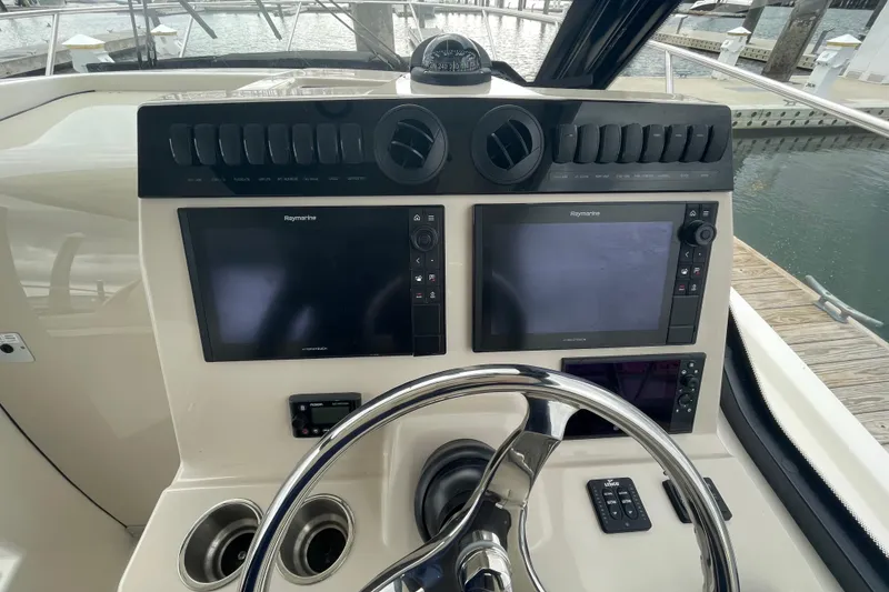 Slide: The Image of Control panel of 2023 Boston Whaler 325 Conquest boat with dual Raymarine displays. - 11