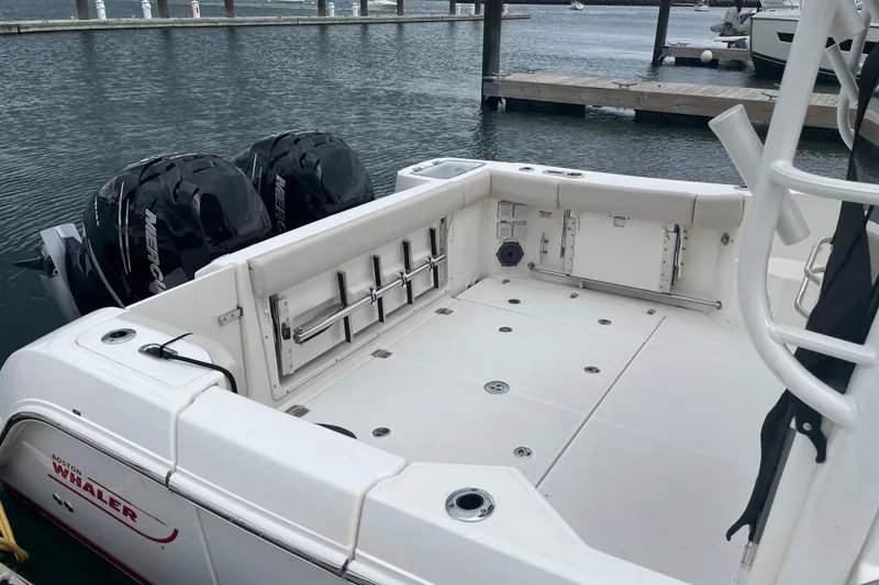Slide: The Image of 2023 Boston Whaler 325 Conquest boat with dual Mercury engines docked at marina. - 5