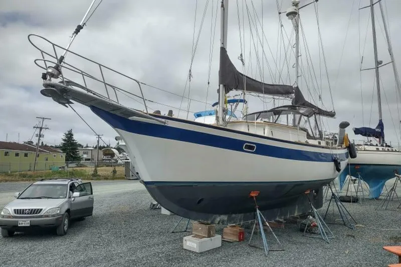 The Image of 1979 Islander Freeport Center Cockpit Ketch docked in a marina, overcast sky. - 0