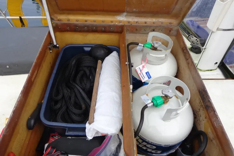 Slide: The Image of Storage compartment on 1979 Islander Freeport Center Cockpit Ketch with propane tanks and boating gear. - 13