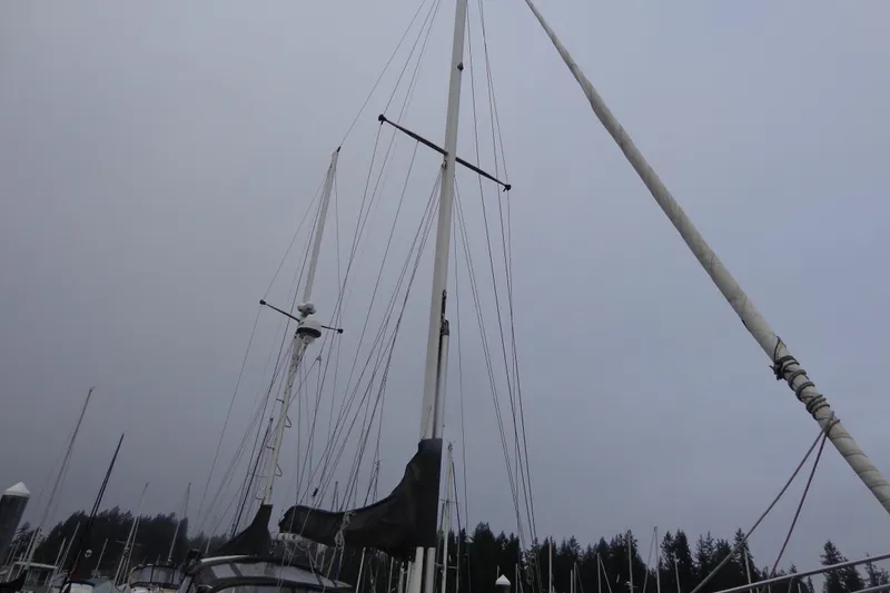 Slide: The Image of 1979 Islander Freeport Center Cockpit Ketch sailboat mast against cloudy sky. - 19