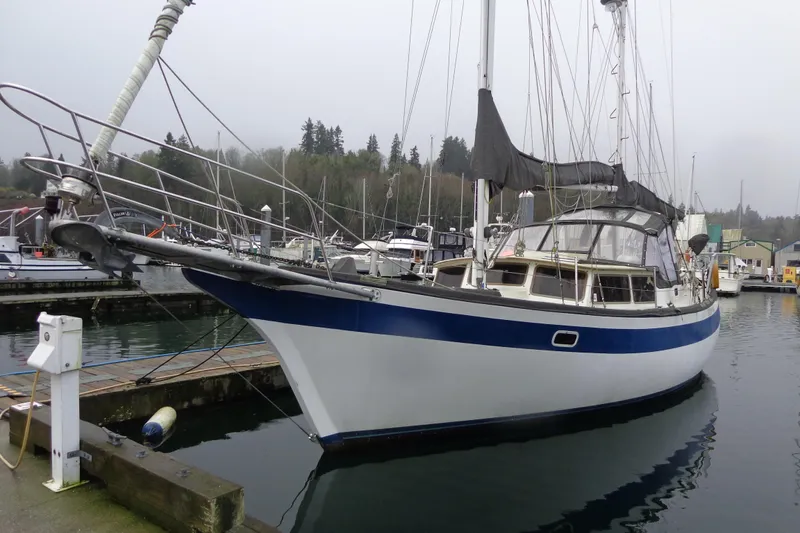 Slide: The Image of 1979 Islander Freeport Center Cockpit Ketch docked at marina, overcast sky. - 2