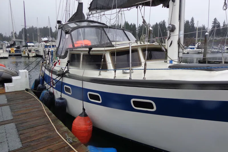 Slide: The Image of 1979 Islander Freeport Center Cockpit Ketch docked at marina, overcast day. - 22