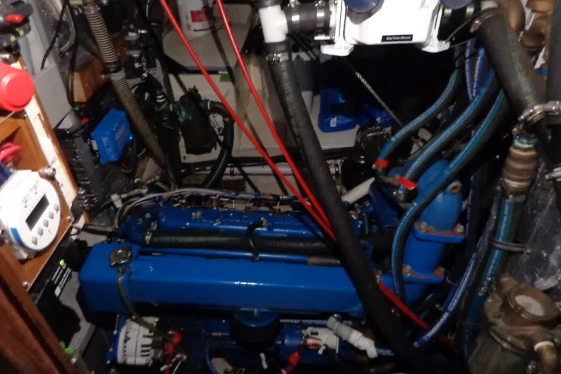Slide: The Image of Engine room of 1979 Islander Freeport Center Cockpit Ketch with blue engine and wiring. - 29
