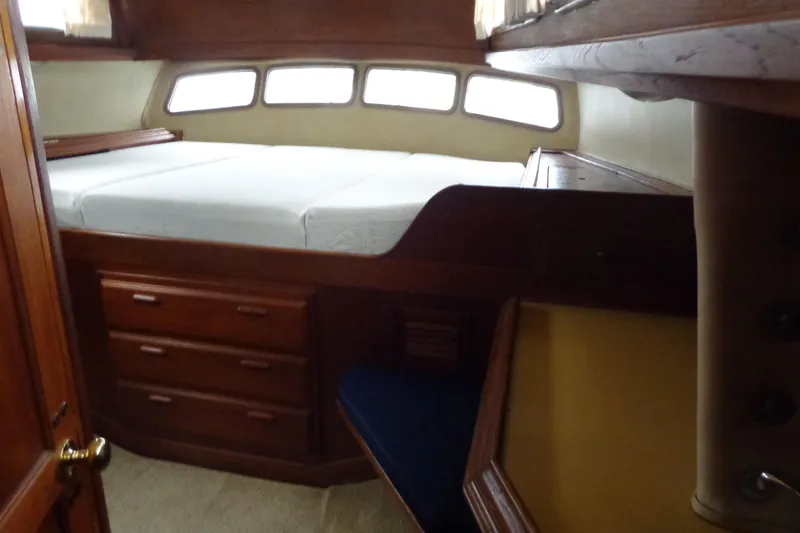 Slide: The Image of 1979 Islander Freeport Center Cockpit Ketch cabin interior with bed and wooden storage drawers. - 31