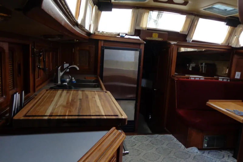 Slide: The Image of Interior of 1979 Islander Freeport Center Cockpit Ketch with wooden cabinetry and dining area. - 35