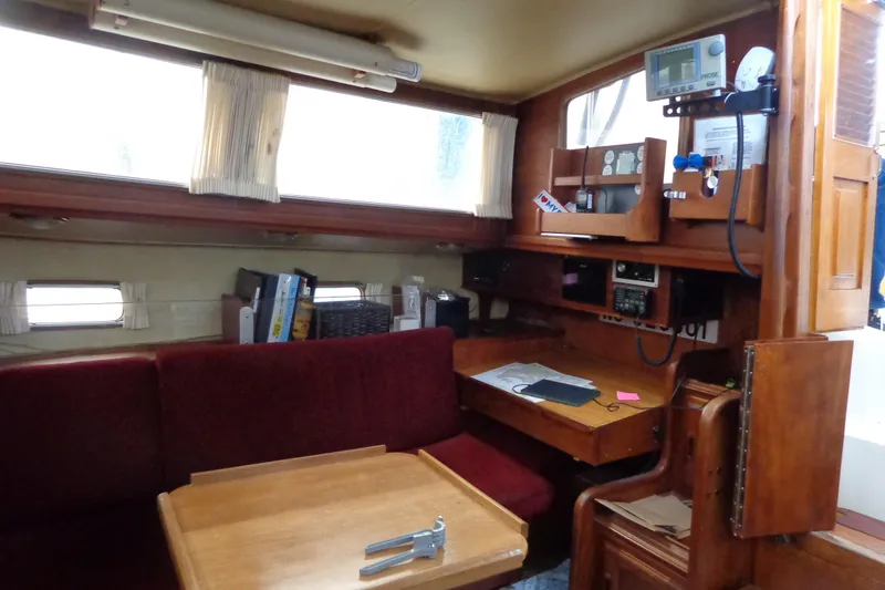 Slide: The Image of Interior of 1979 Islander Freeport Center Cockpit Ketch with navigation station and seating area. - 37