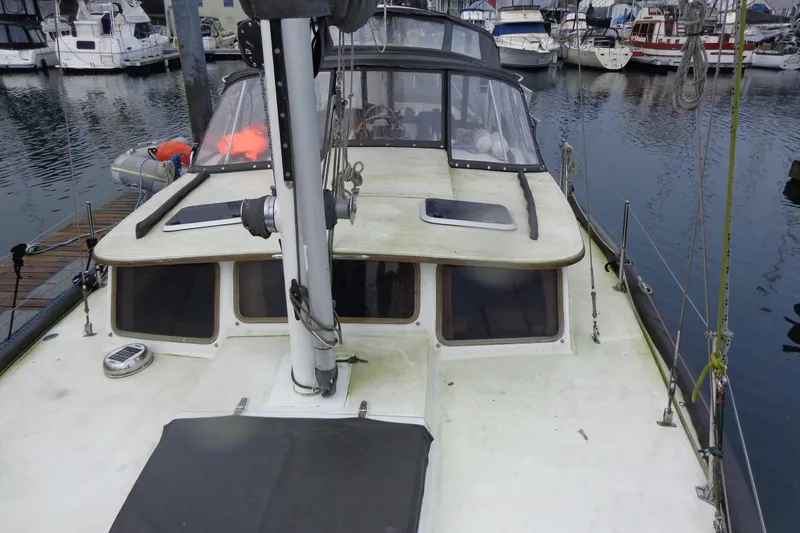 Slide: The Image of 1979 Islander Freeport Center Cockpit Ketch docked at marina, showcasing deck and cabin. - 5