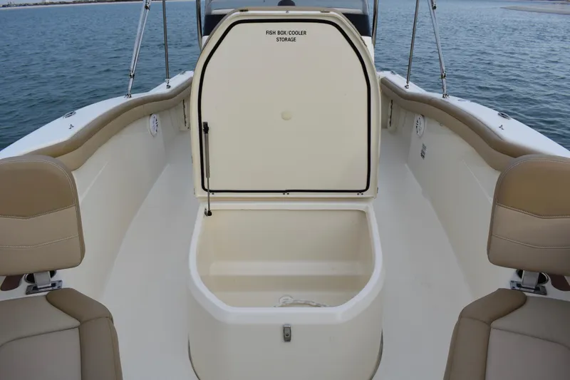 Slide: The Image of 2020 Scout 215 XSF boat dashboard with steering wheel and navigation controls on water. - 13