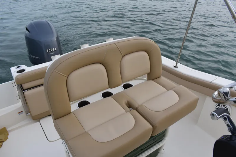 Slide: The Image of 2020 Scout 215 XSF boat with beige seating and Yamaha 150 outboard motor. - 16