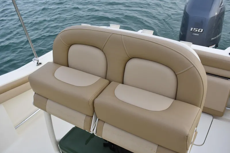Slide: The Image of 2020 Scout 215 XSF boat interior with rod holders and cooler on deck. - 17