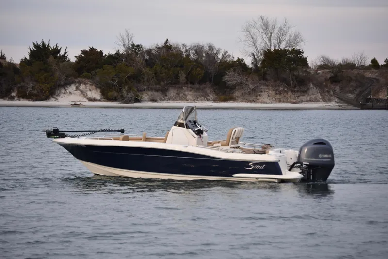 Slide: The Image of 2020 Scout 215 XSF boat interior with tan seating, on calm water. - 8