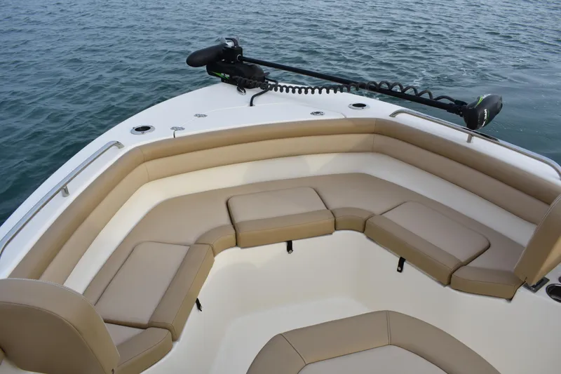 Slide: The Image of 2020 Scout 215 XSF boat with tan seating and trolling motor on calm water. - 9