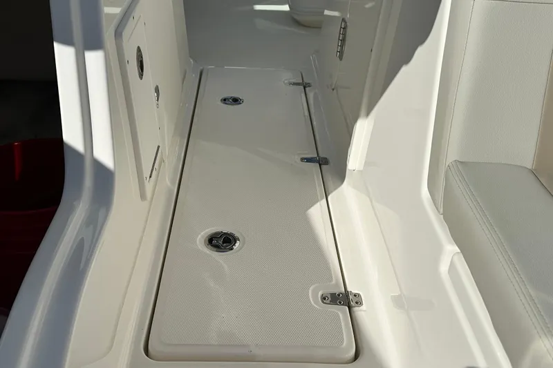 Slide: The Image of Boston Whaler 240 Vantage 2026, interior with storage and seating area. - 13