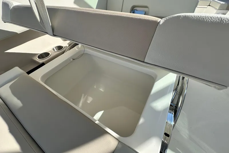 Slide: The Image of Boston Whaler 240 Vantage 2026, seat storage compartment with cup holders. - 27