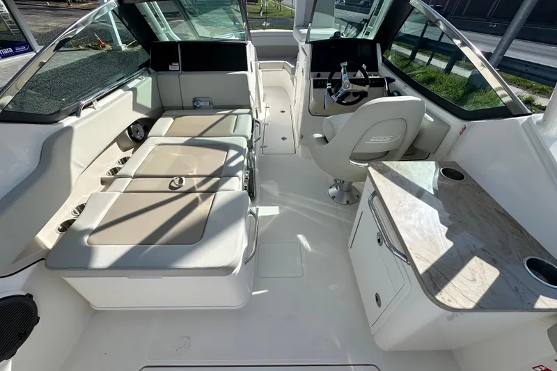 Slide: The Image of Interior of 2026 Boston Whaler 240 Vantage with seating and helm station. - 28