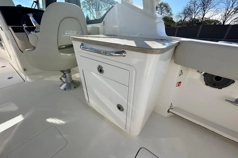 Slide: The Image of Interior of 2026 Boston Whaler 240 Vantage with seating and storage. - 30