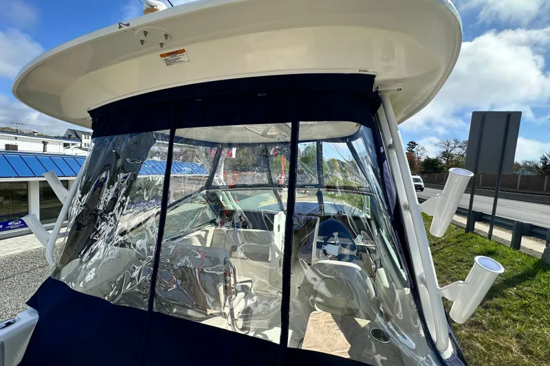 Slide: The Image of 2026 Boston Whaler 240 Vantage with enclosed cabin and clear windows. - 46