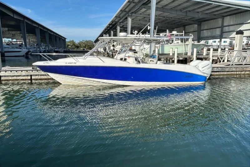 Slide: The Image of 2008 Boston Whaler 320 Outrage Cuddy Cabin boat docked in marina. - 0