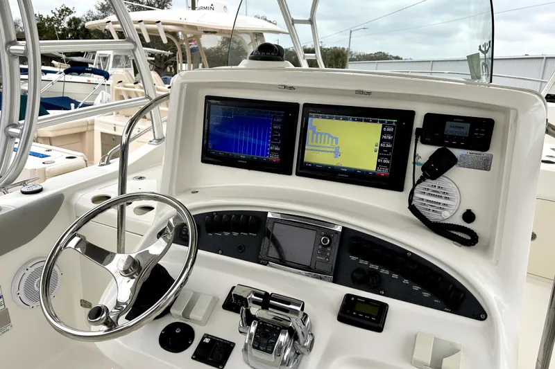 Slide: The Image of 2008 Boston Whaler 320 Outrage Cuddy Cabin helm with navigation screens and controls. - 1