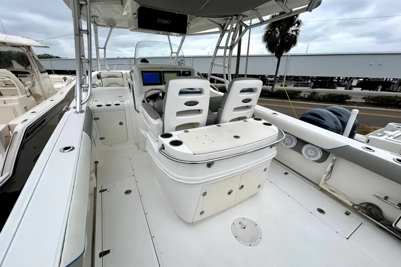 Slide: The Image of 2008 Boston Whaler 320 Outrage Cuddy Cabin interior with helm and seating area. - 10