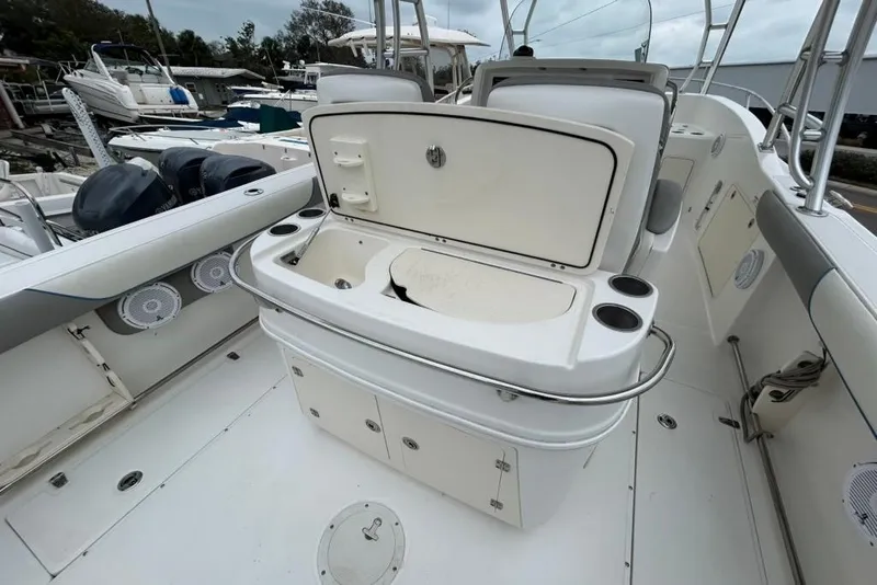 Slide: The Image of 2008 Boston Whaler 320 Outrage Cuddy Cabin interior with open storage and cup holders. - 13