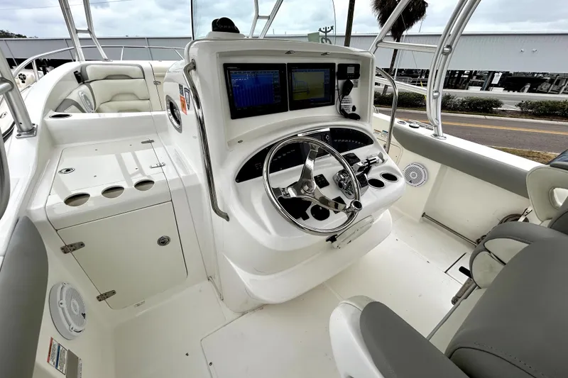 Slide: The Image of 2008 Boston Whaler 320 Outrage Cuddy Cabin helm with modern navigation equipment and seating. - 2