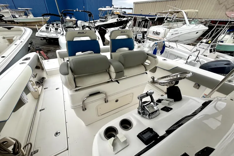 Slide: The Image of 2008 Boston Whaler 320 Outrage Cuddy Cabin interior with helm and seating area. - 3