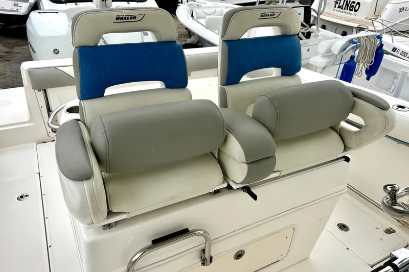 Slide: The Image of 2008 Boston Whaler 320 Outrage Cuddy Cabin boat seats, featuring blue and gray upholstery. - 4