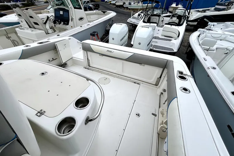Slide: The Image of 2008 Boston Whaler 320 Outrage Cuddy Cabin boat interior with seating and storage. - 8