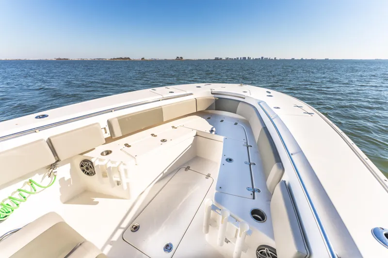 Slide: The Image of 2021 Cape Horn 32 XS boat on open water, featuring spacious seating and clear skies. - 11
