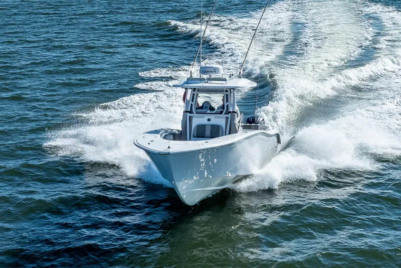 Slide: The Image of 2021 Cape Horn 32 XS boat cruising on open water, creating a dynamic wake. - 3