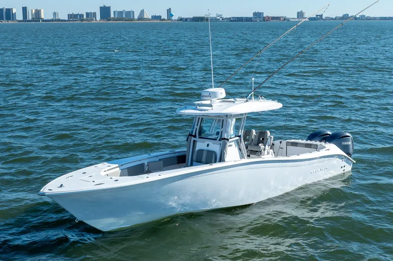 Slide: The Image of 2021 Cape Horn 32 XS boat on open water with city skyline in background. - 4