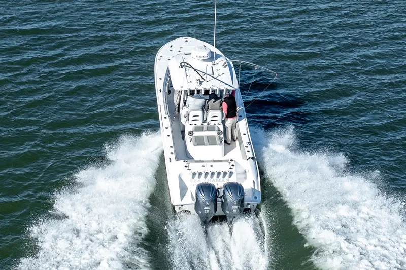 Slide: The Image of 2021 Cape Horn 32 XS boat cruising on open water, rear view. - 6