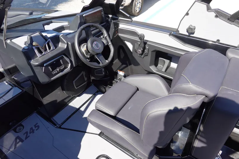 Slide: The Image of 2026 Axis A245 boat interior with modern steering and seating design. - 16