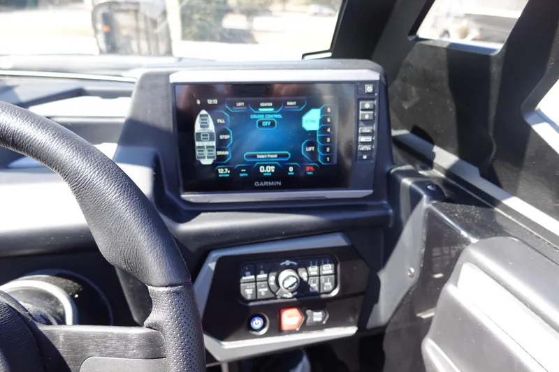 Slide: The Image of Dashboard of 2026 Axis A245 boat with Garmin display and controls. - 18