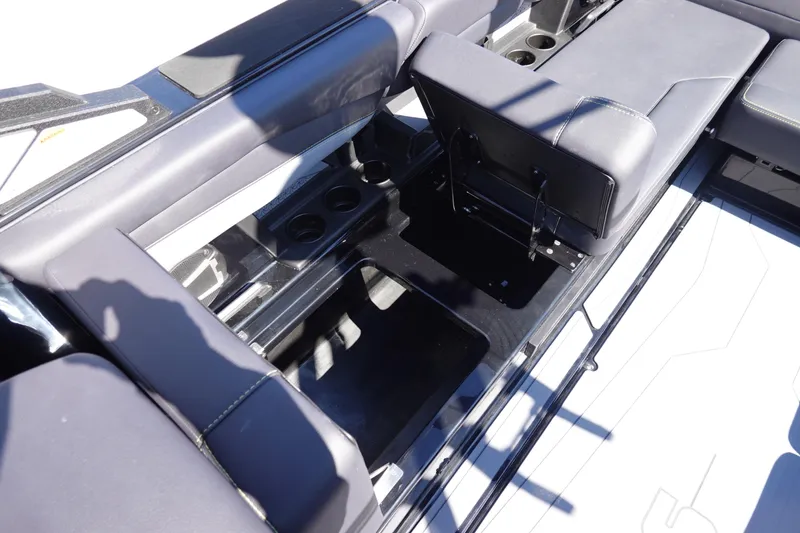 Slide: The Image of 2026 Axis A245 boat interior with open storage compartments and cup holders. - 20