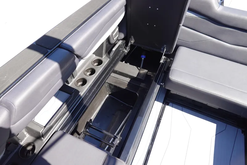Slide: The Image of 2026 Axis A245 boat interior with open storage compartment and cup holders. - 21