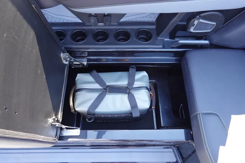 Slide: The Image of Storage compartment in 2026 Axis A245 boat with a secured bag inside. - 27