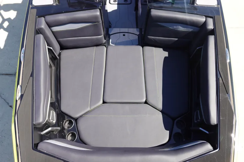 Slide: The Image of 2026 Axis A245 boat interior with black cushioned seating and cup holders. - 35